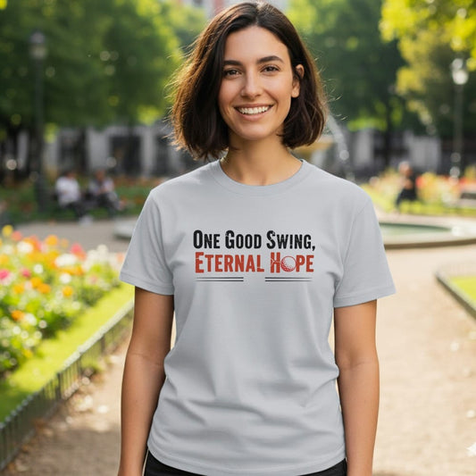 Light grey t-shirt with "One Good Swing, Eternal Hope" and a golf ball.