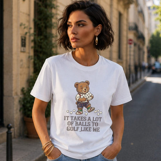 T-shirt with a cartoon bear holding golf balls and text: "It takes a lot of balls to golf like me."