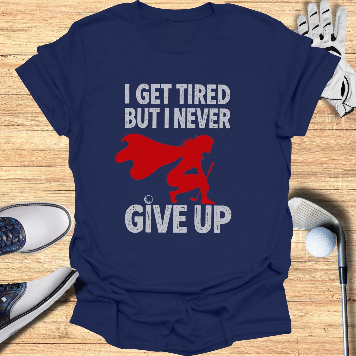 Navy t-shirt with text "I GET TIRED BUT I NEVER GIVE UP" and a superhero graphic.