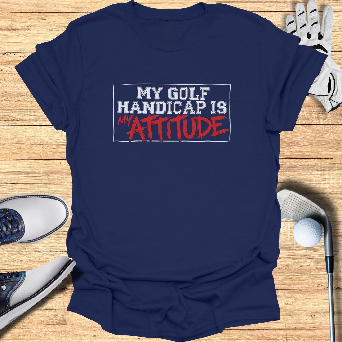 Navy t-shirt with "MY GOLF HANDICAP IS MY ATTITUDE" text.