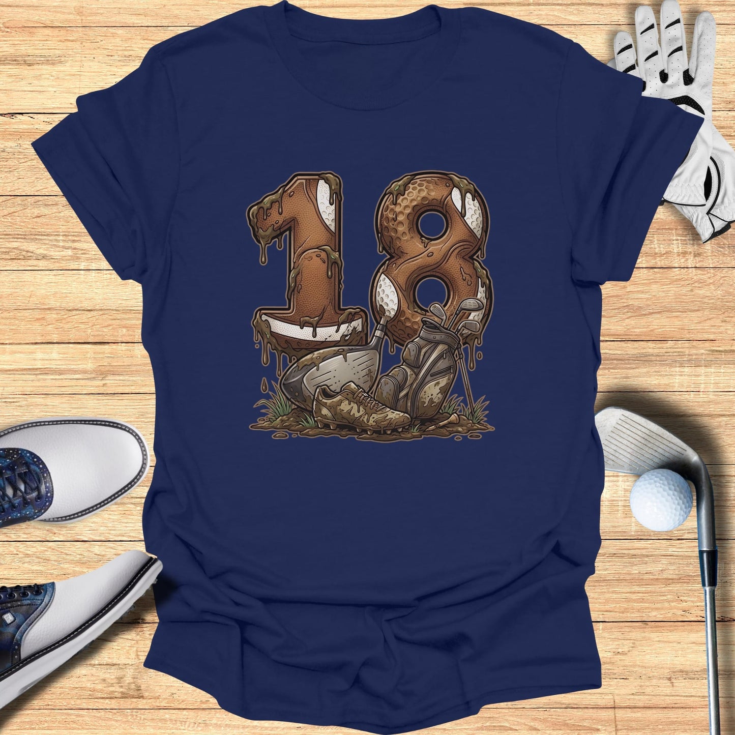 Navy t-shirt with "18" made of footballs and golf clubs in mud.