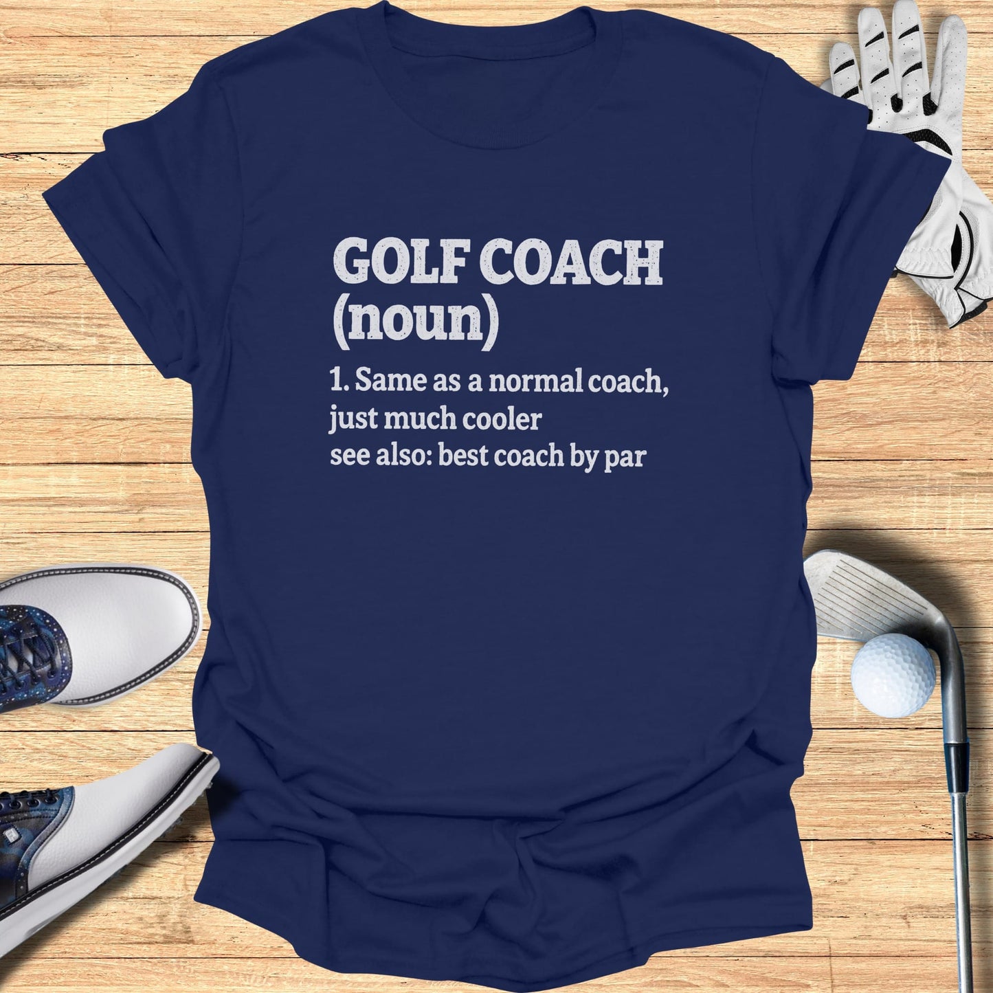 Navy t-shirt with text: "GOLF COACH (noun): Same as a normal coach, just much cooler. see also: best coach by par."