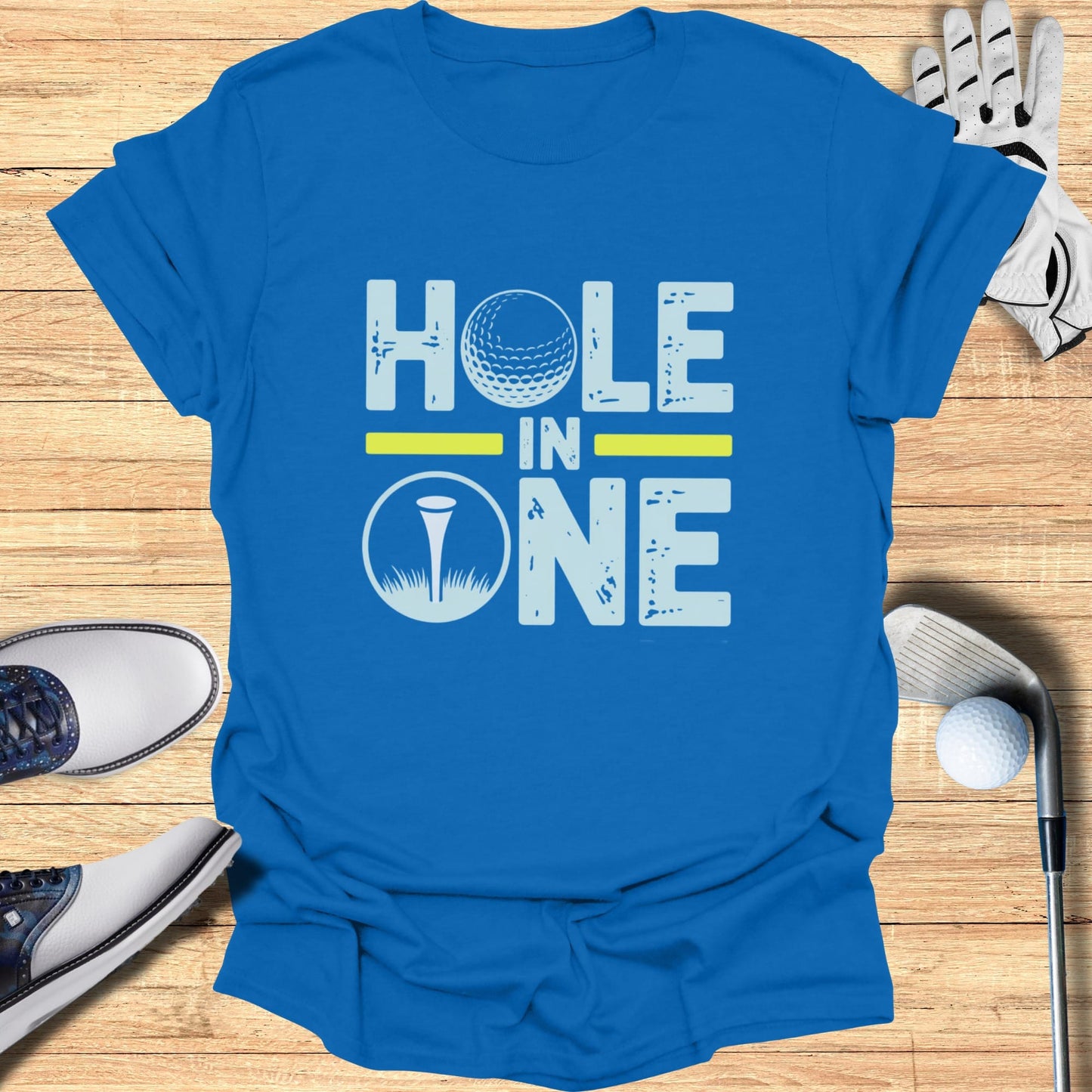 Blue t-shirt with "HOLE IN ONE" text and golf ball graphic.
