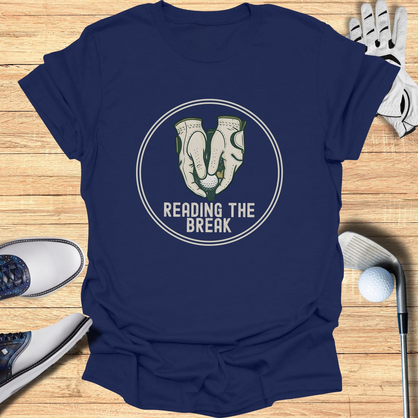 Navy t-shirt with "Reading the Break" golf graphic on wooden background.