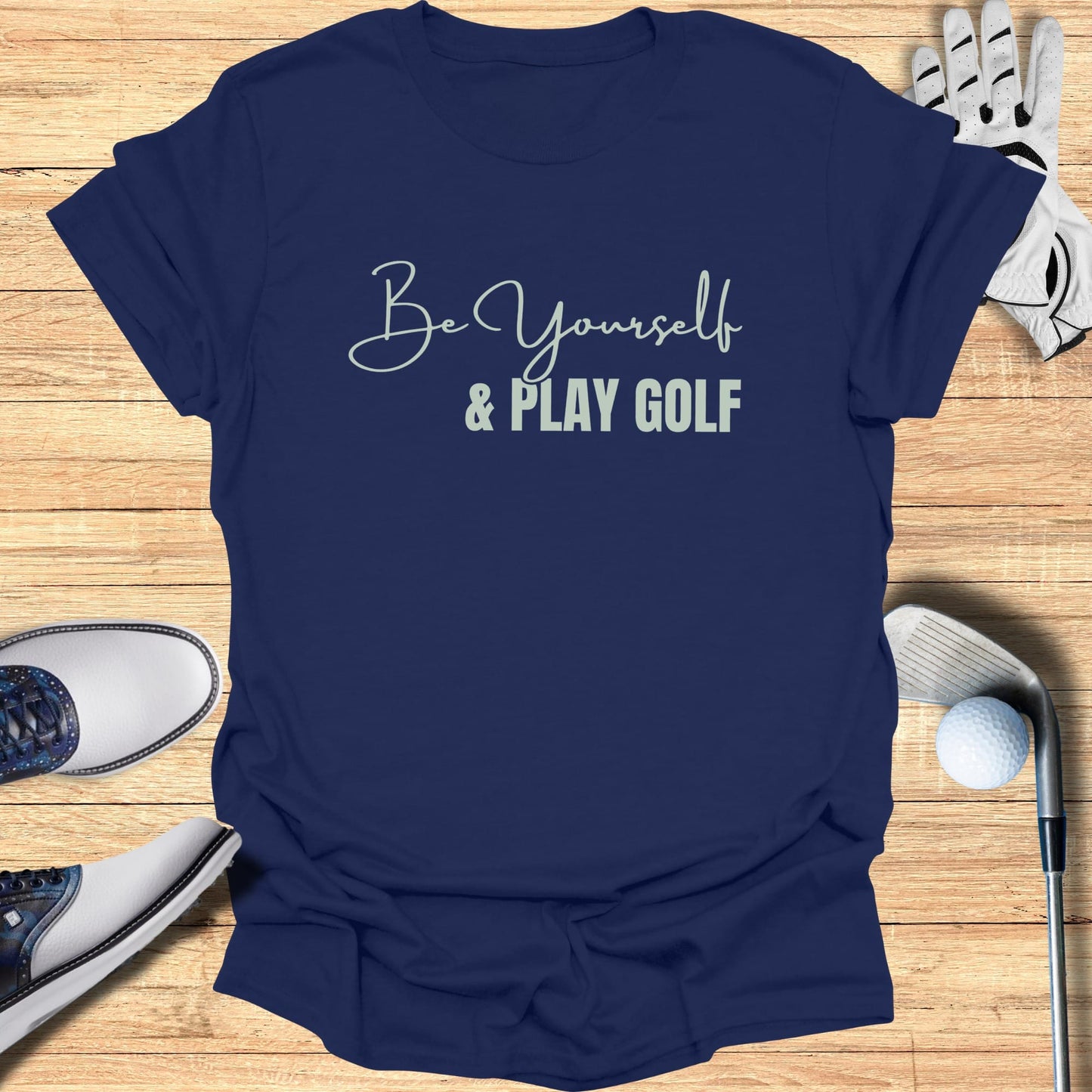Navy t-shirt with "Be Yourself & Play Golf" text, golf shoes, and glove.