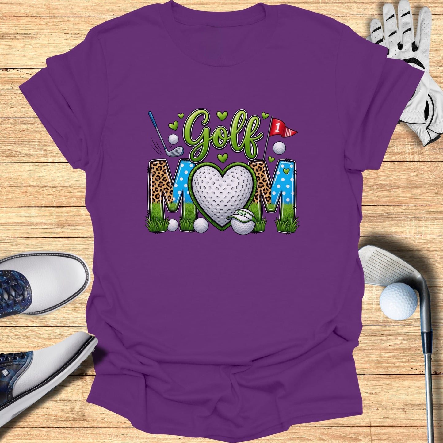 Purple t-shirt with "Golf Mom" text and heart-shaped golf ball graphic.