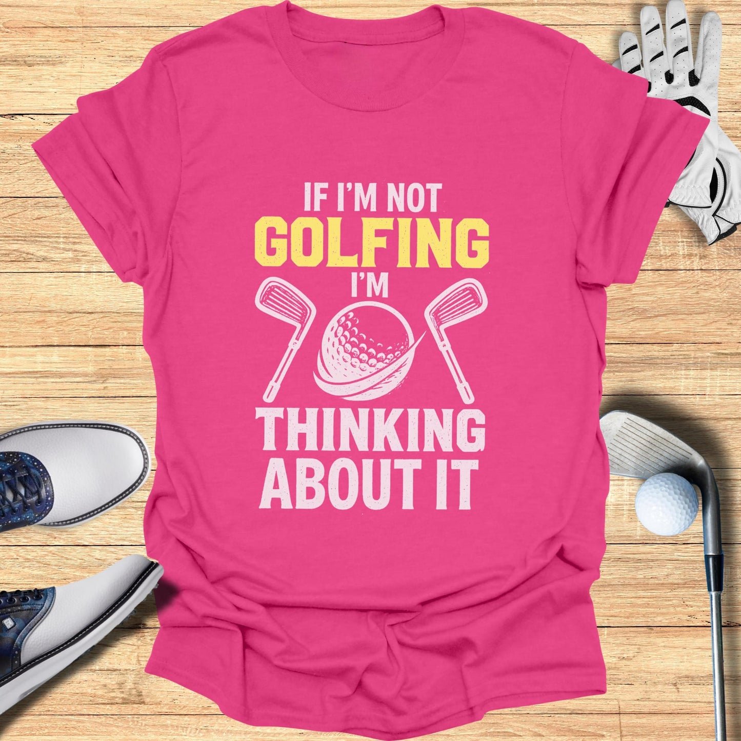 Pink t-shirt with "If I'm not golfing, I'm thinking about it" graphic.