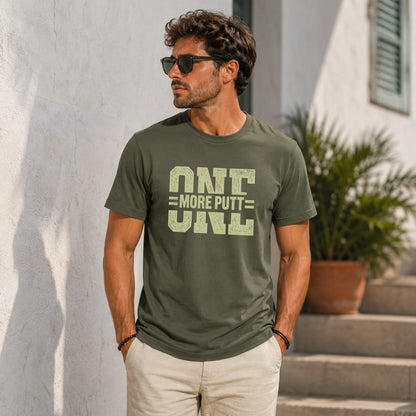 Olive green t-shirt with "ONE MORE PUTT" text, worn by a man.