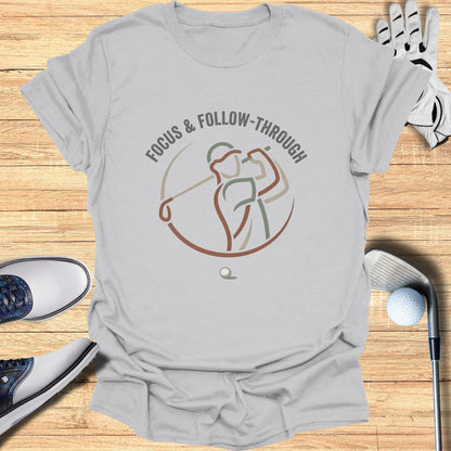 Gray t-shirt with a minimalist golf swing graphic and text "FOCUS & FOLLOW-THROUGH".