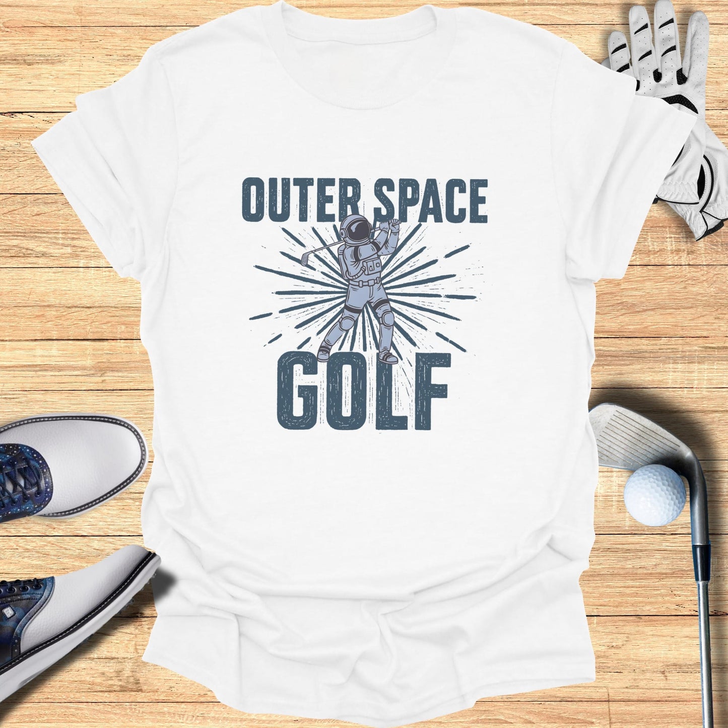 White t-shirt with astronaut golfing in outer space graphic and text.