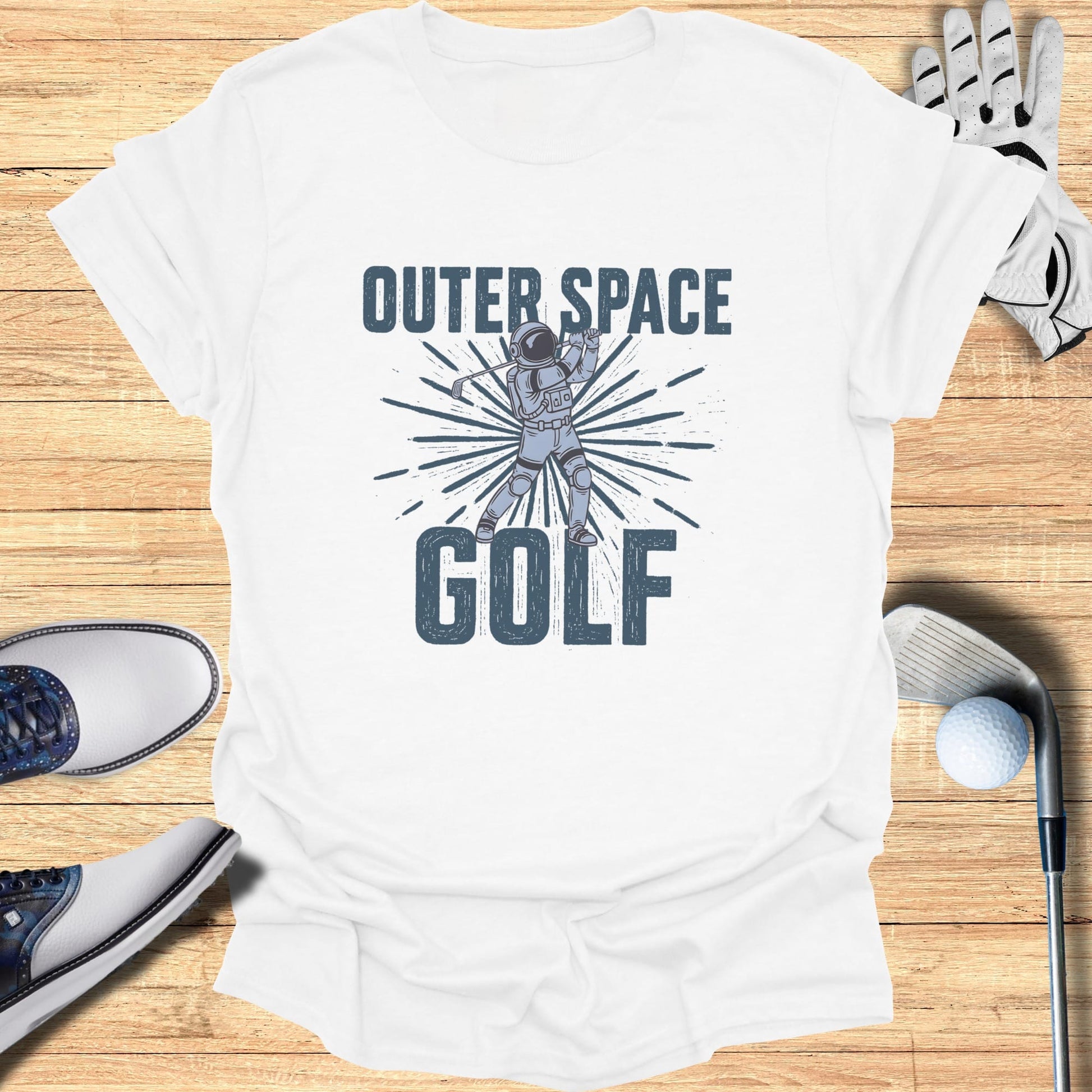 White t-shirt with astronaut golfing in outer space graphic and text.