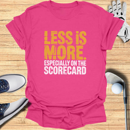 Pink t-shirt with "Less is More" and "Especially on the Scorecard" text.