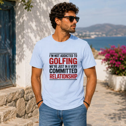 Light blue t-shirt with bold red text reading "I'm not addicted to golfing we're just in a very committed relationship".
