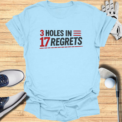 Light blue t-shirt with "3 HOLES IN 17 REGRETS" in red and black text.