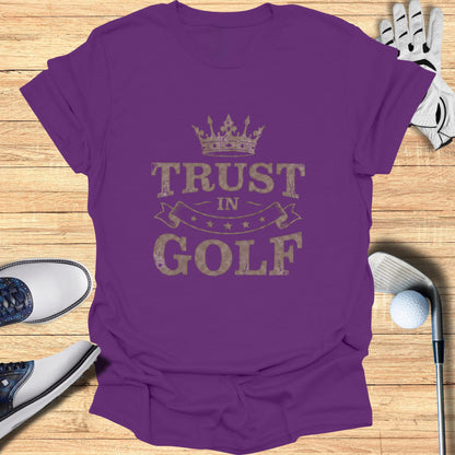 Purple t-shirt with "Trust in Golf" text and crown graphic.