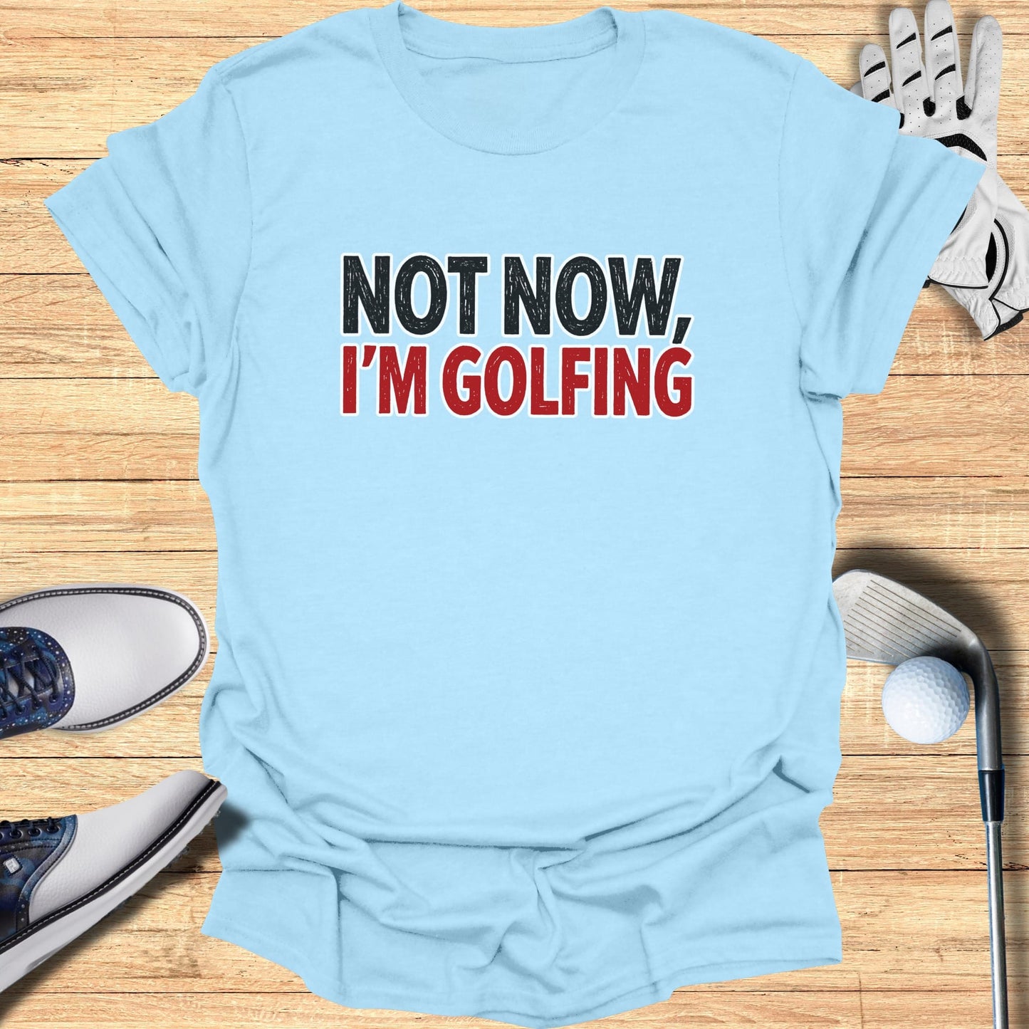 Light blue t-shirt with "NOT NOW, I'M GOLFING" text.