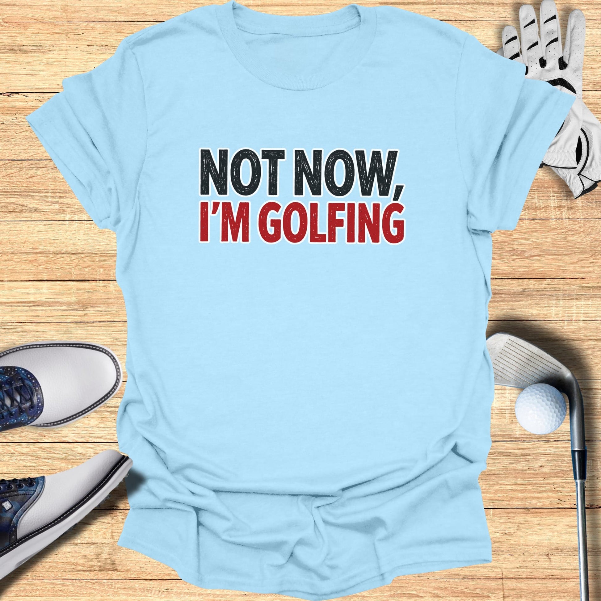 Light blue t-shirt with "NOT NOW, I'M GOLFING" text.