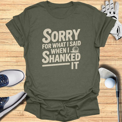 Olive t-shirt with "SORRY WHEN I SHANKED IT" text and golf accessories.
