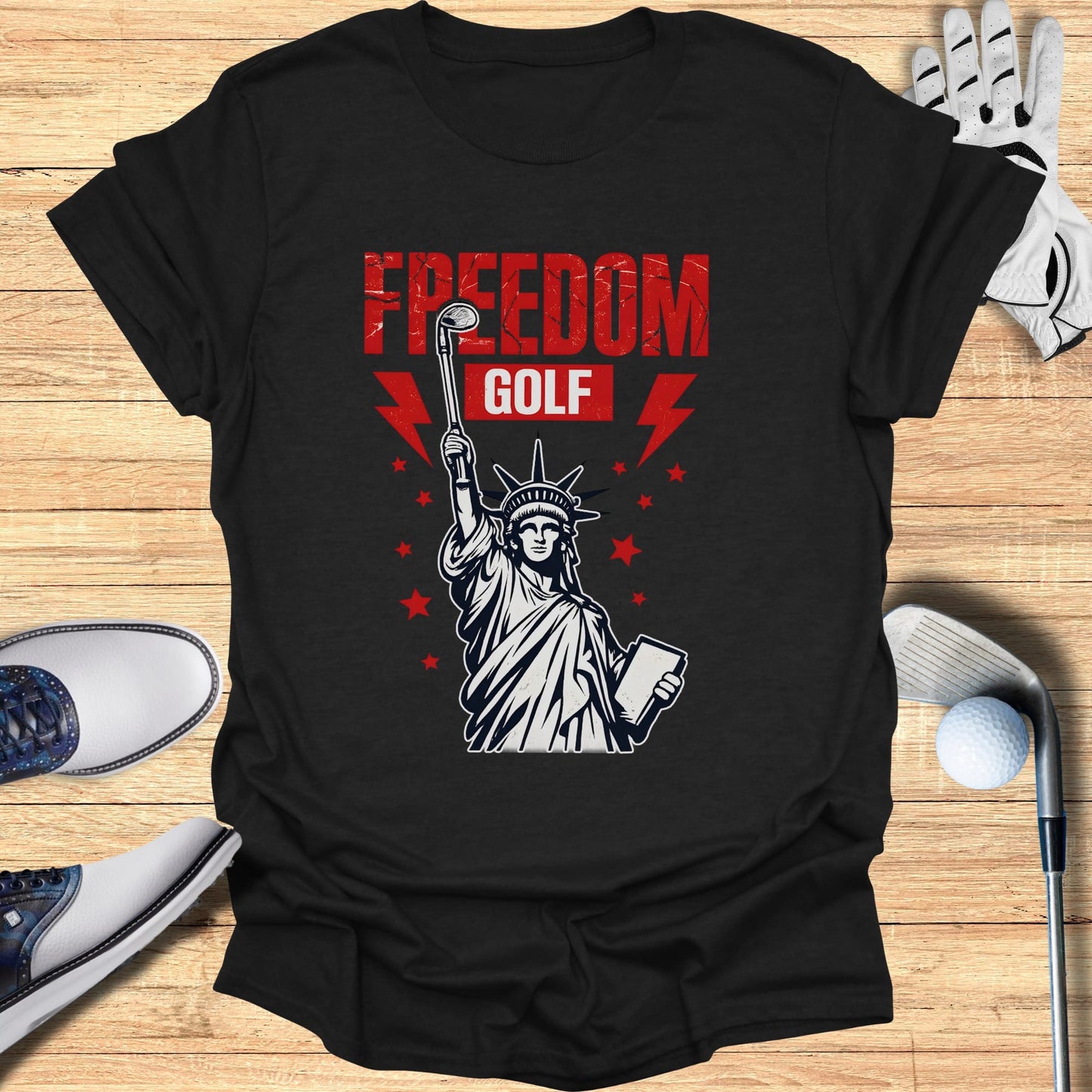 T-shirt with Statue of Liberty holding a golf club and book, "Freedom Golf" text.