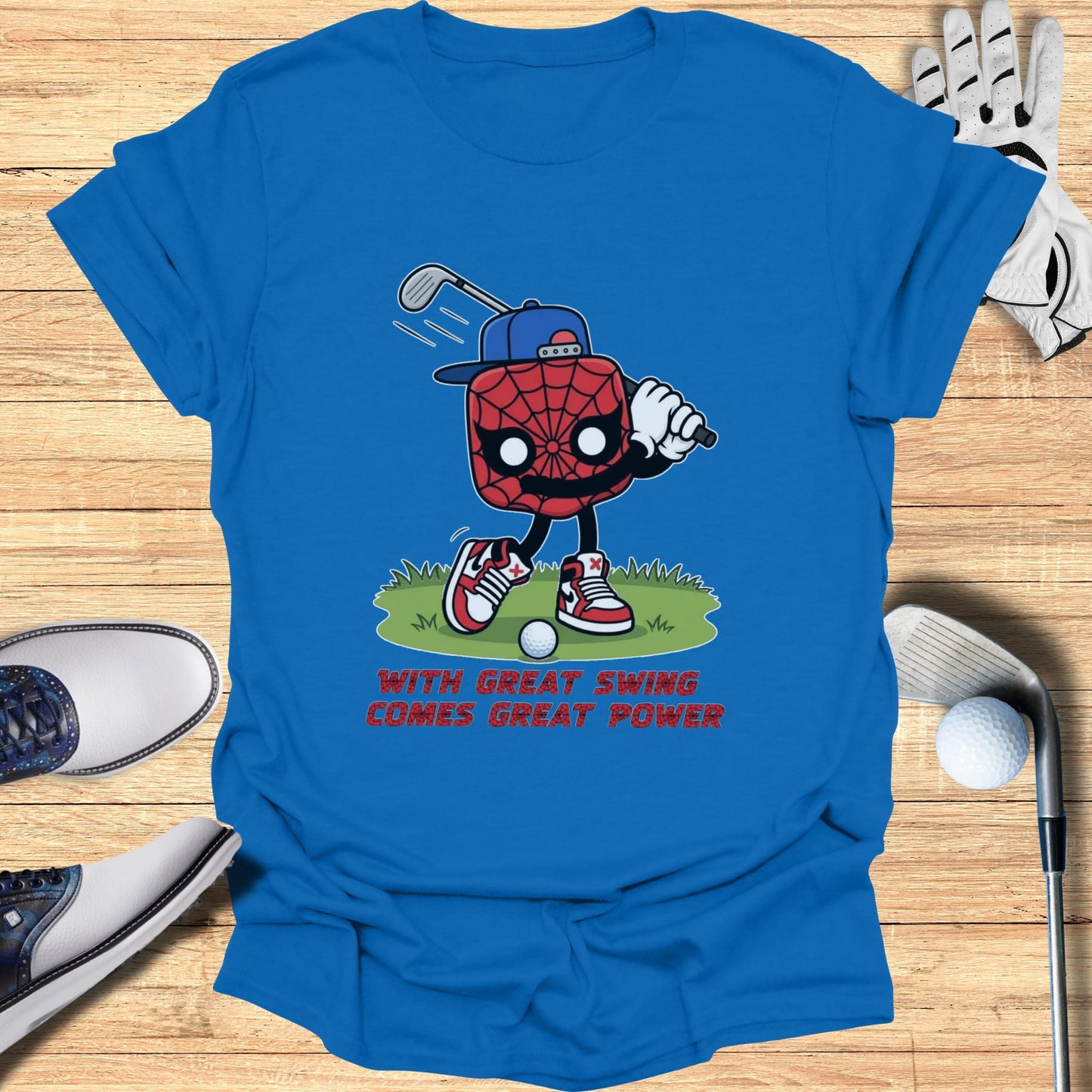 Spiderman character swinging golf club on blue t-shirt with text.