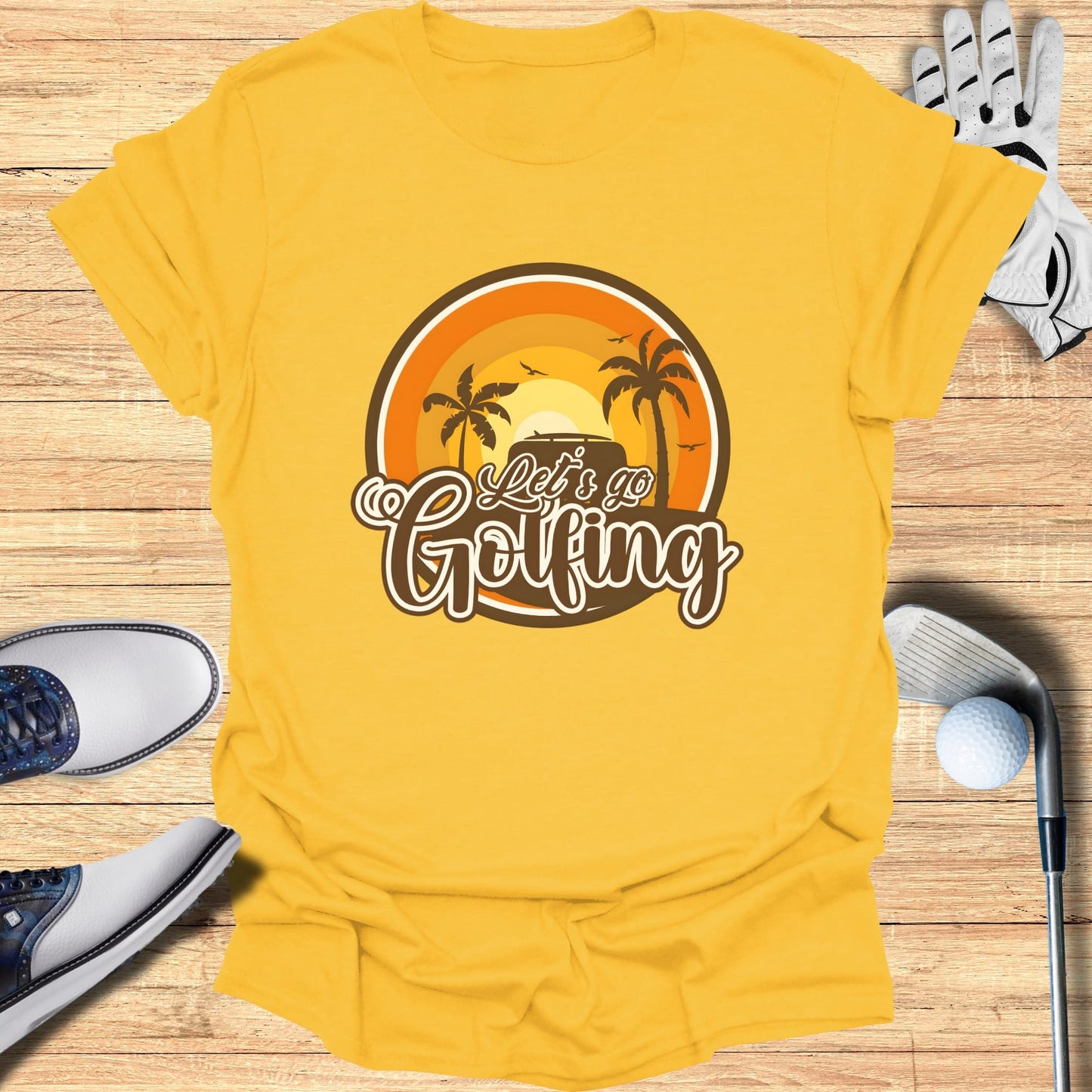 Yellow t-shirt with "Let's Go Golfing" text and a sunset golf scene.