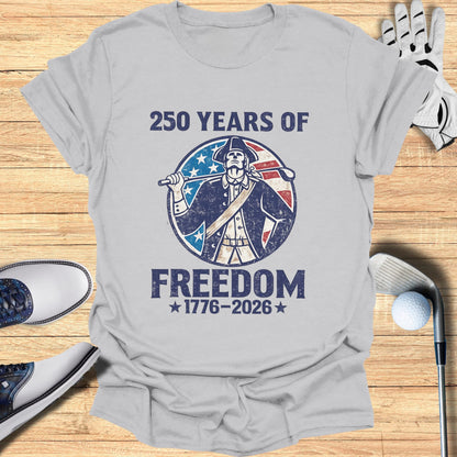 T-shirt with a colonial figure holding a golf club, "250 Years of Freedom 1776-2026".
