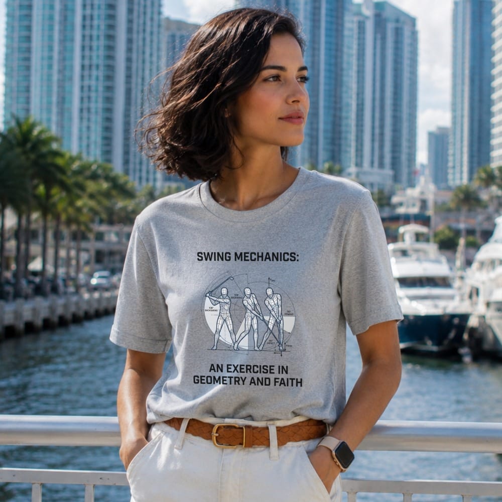 Gray t-shirt with diagram of golf swing mechanics and text "AN EXERCISE IN GEOMETRY AND FAITH".