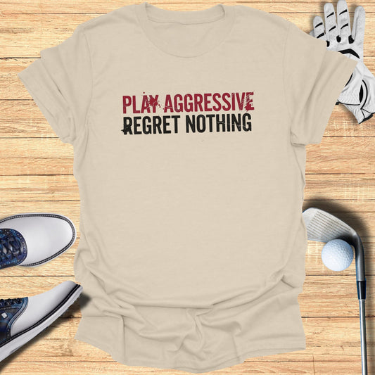 Tan t-shirt with "PLAY AGGRESSIVE REGRET NOTHING" text and golf accessories.