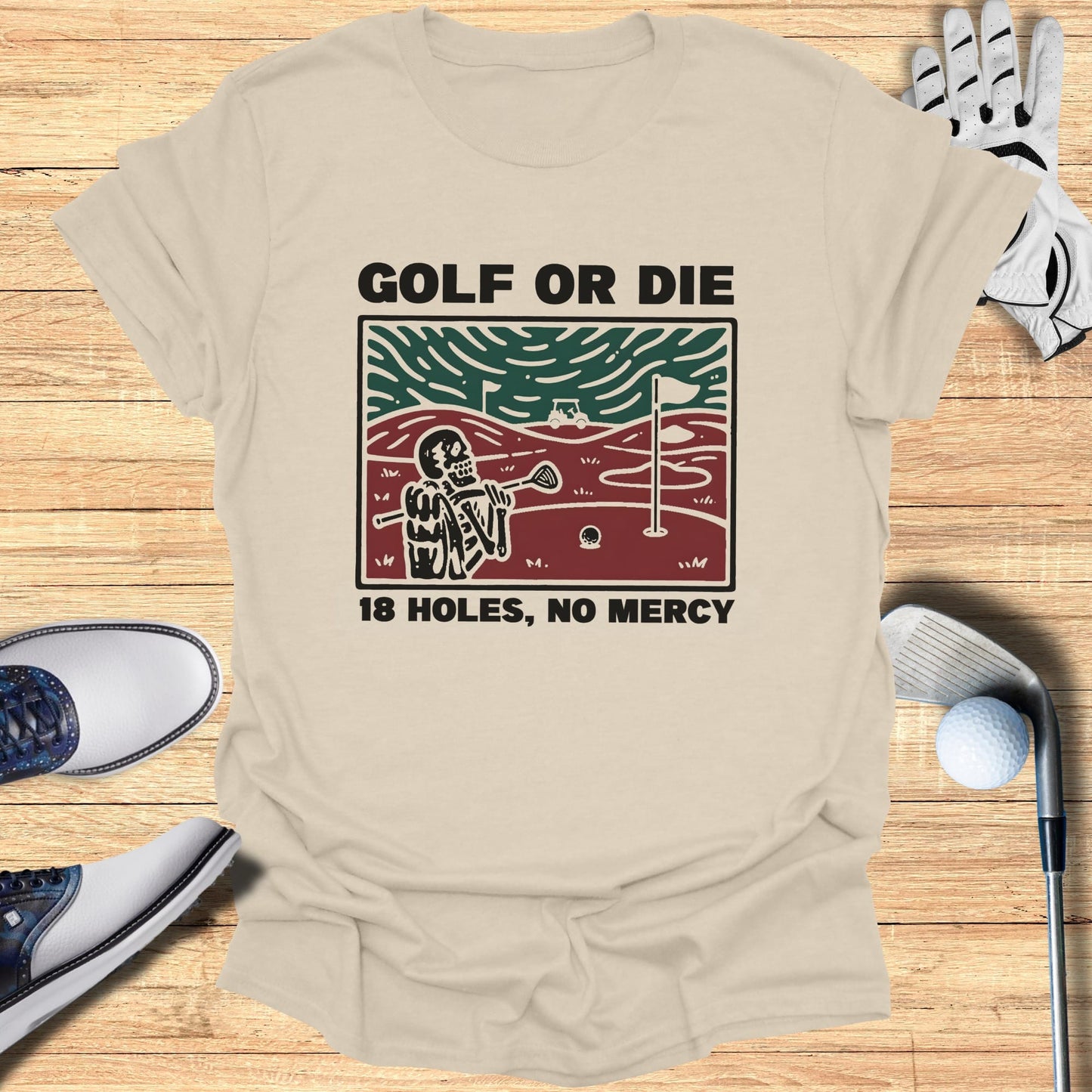 Light tan t-shirt with "GOLF OR DIE 18 HOLES, NO MERCY" and a skeleton golfer graphic.