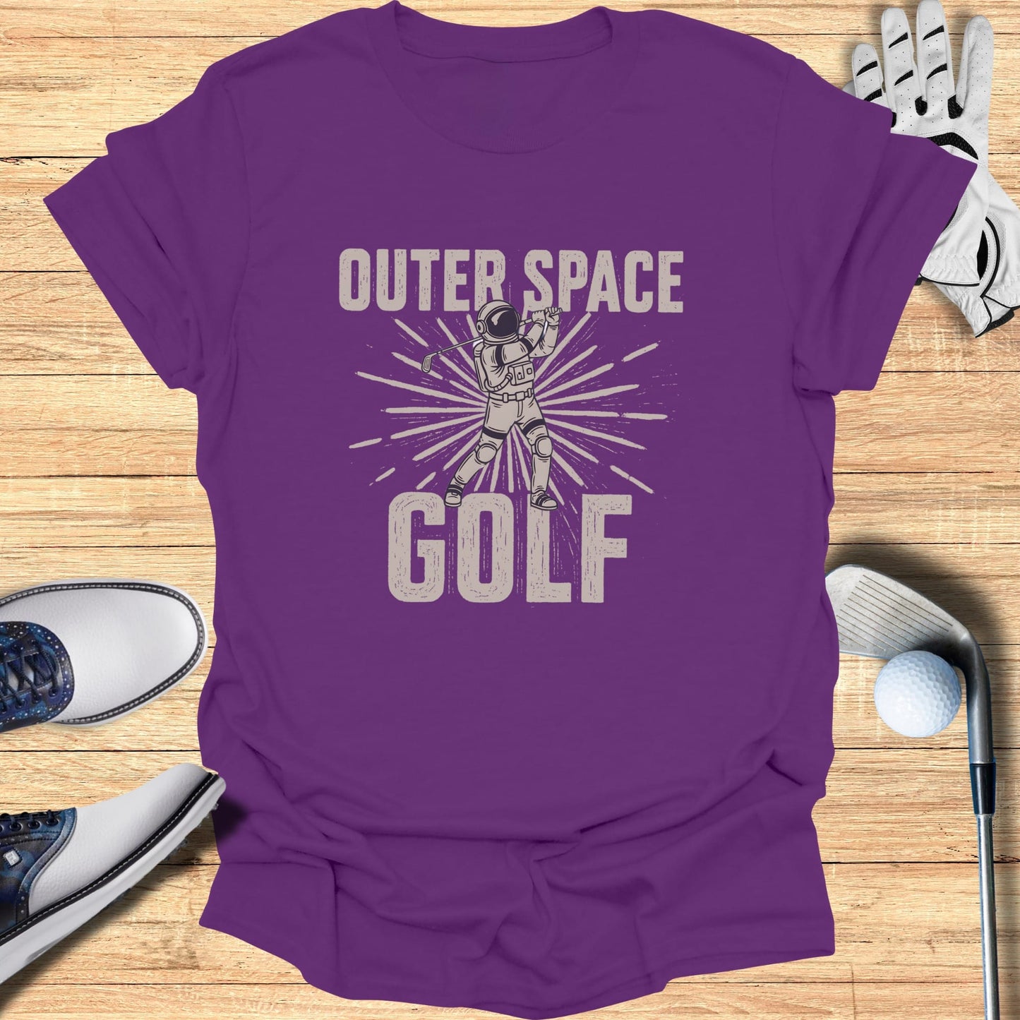 Purple t-shirt with "Outer Space Golf" graphic of astronaut playing golf.