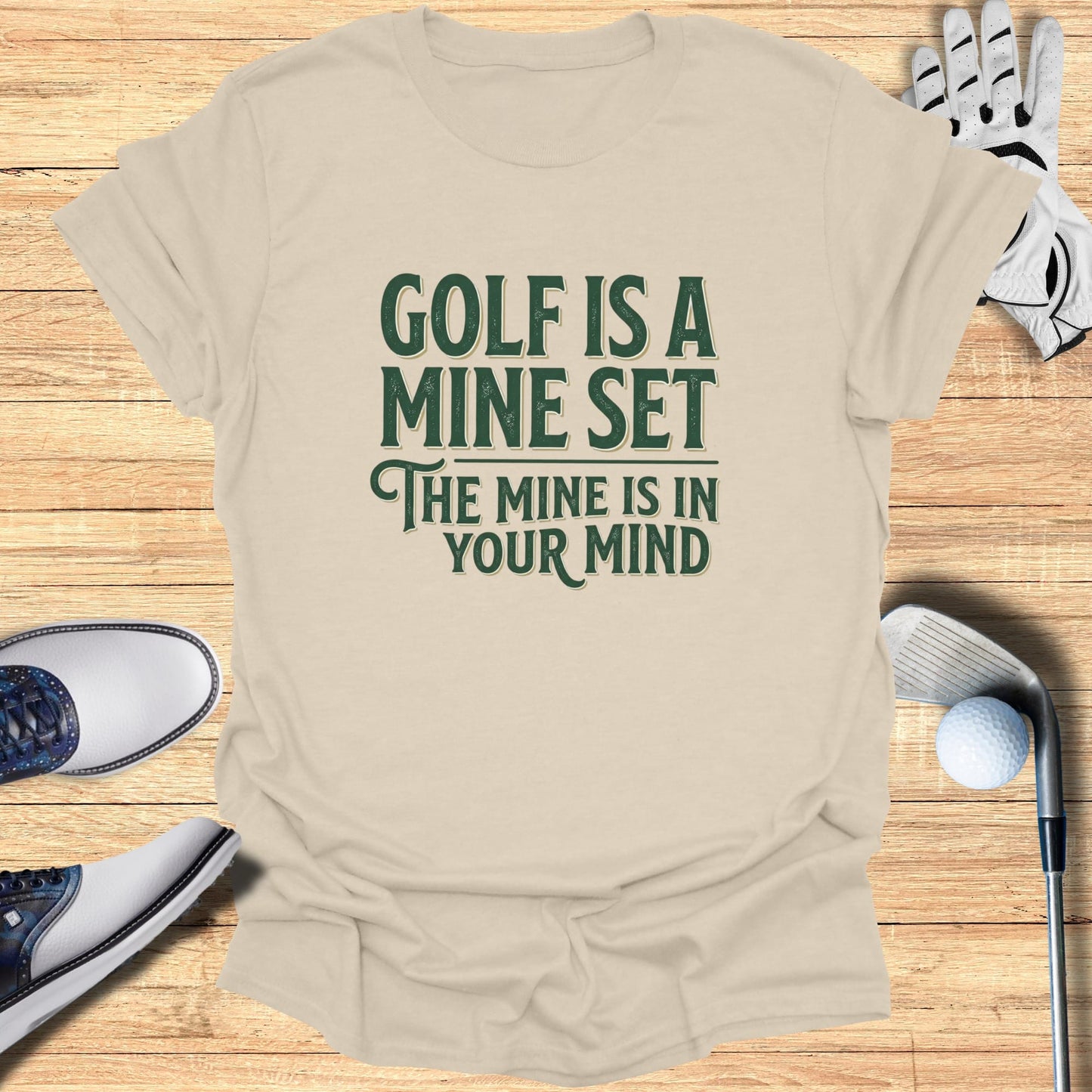 T-shirt with "Golf is a mindset" text, surrounded by golf accessories.
