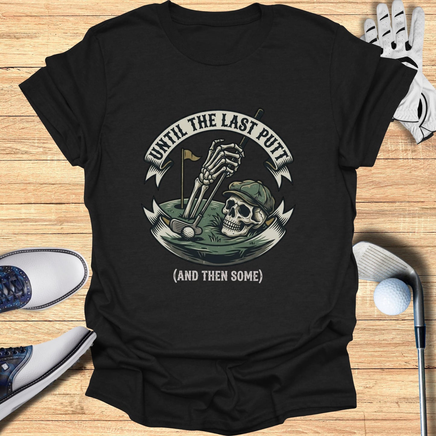 Black t-shirt with skull graphic, golf clubs, and text "Until the last putt (and then some)".
