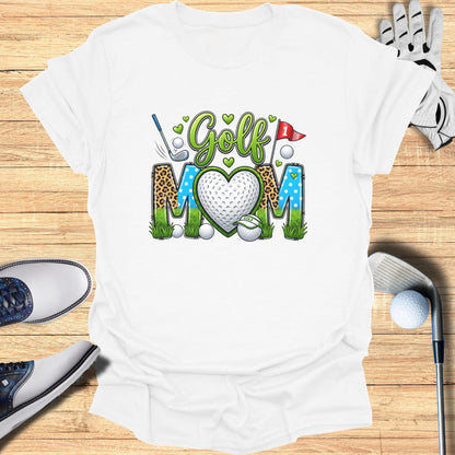 T-shirt with "Golf Mom" text and golf imagery on a wooden background.