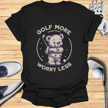 Bear wearing golf clothes holding a club on a dark t-shirt.