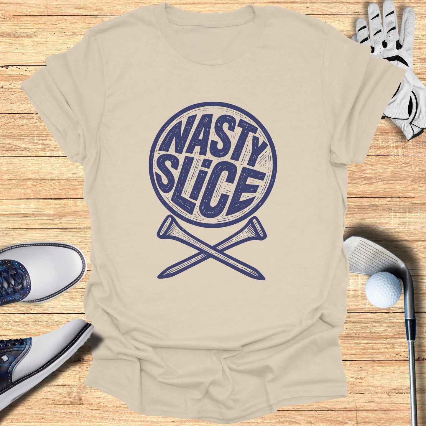 Beige t-shirt with circular "NASTY SLICE" logo and crossed golf tees.