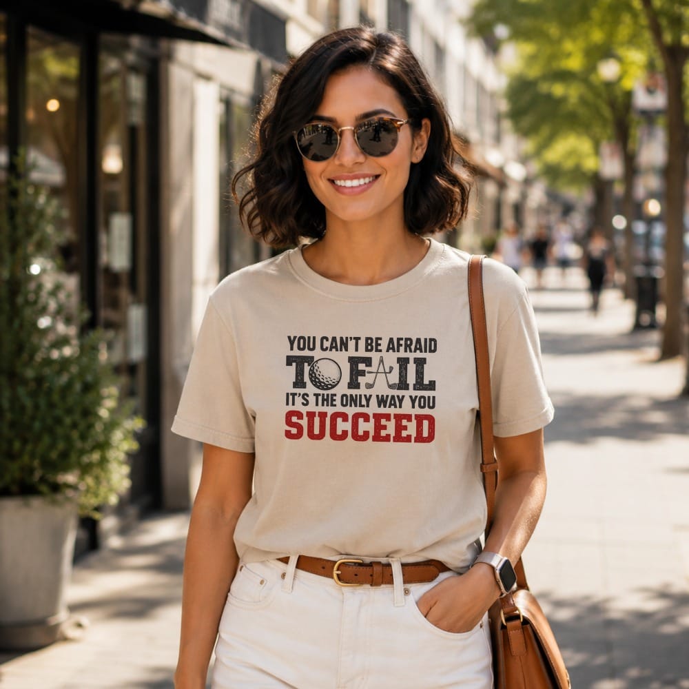 Woman wearing t-shirt with text "You can't be afraid to fail. It's the only way you succeed."