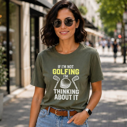 Woman wearing olive green t-shirt with "If I'm Not Golfing I'm Thinking About It" text.