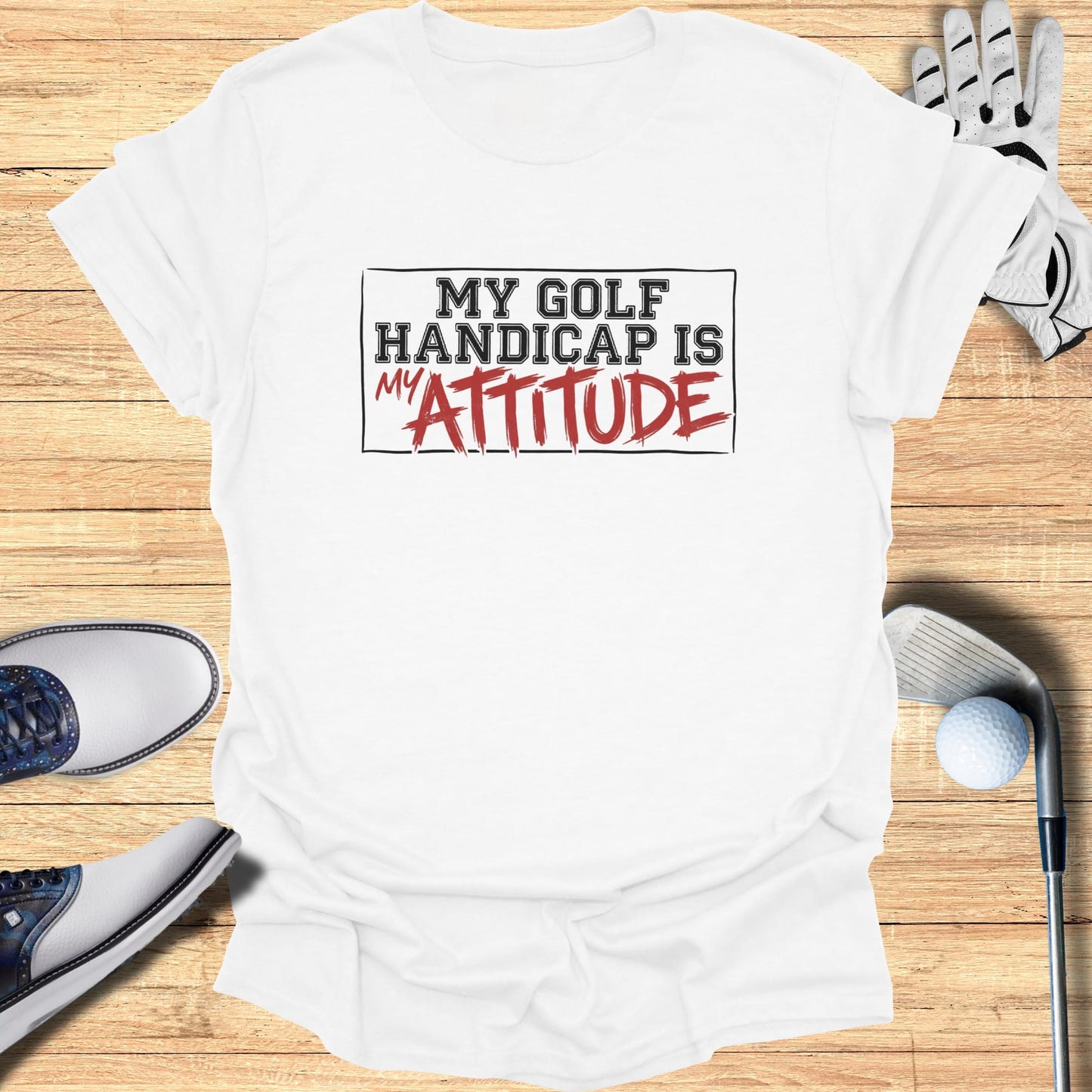 White t-shirt with "My Golf Handicap Is My Attitude" text.