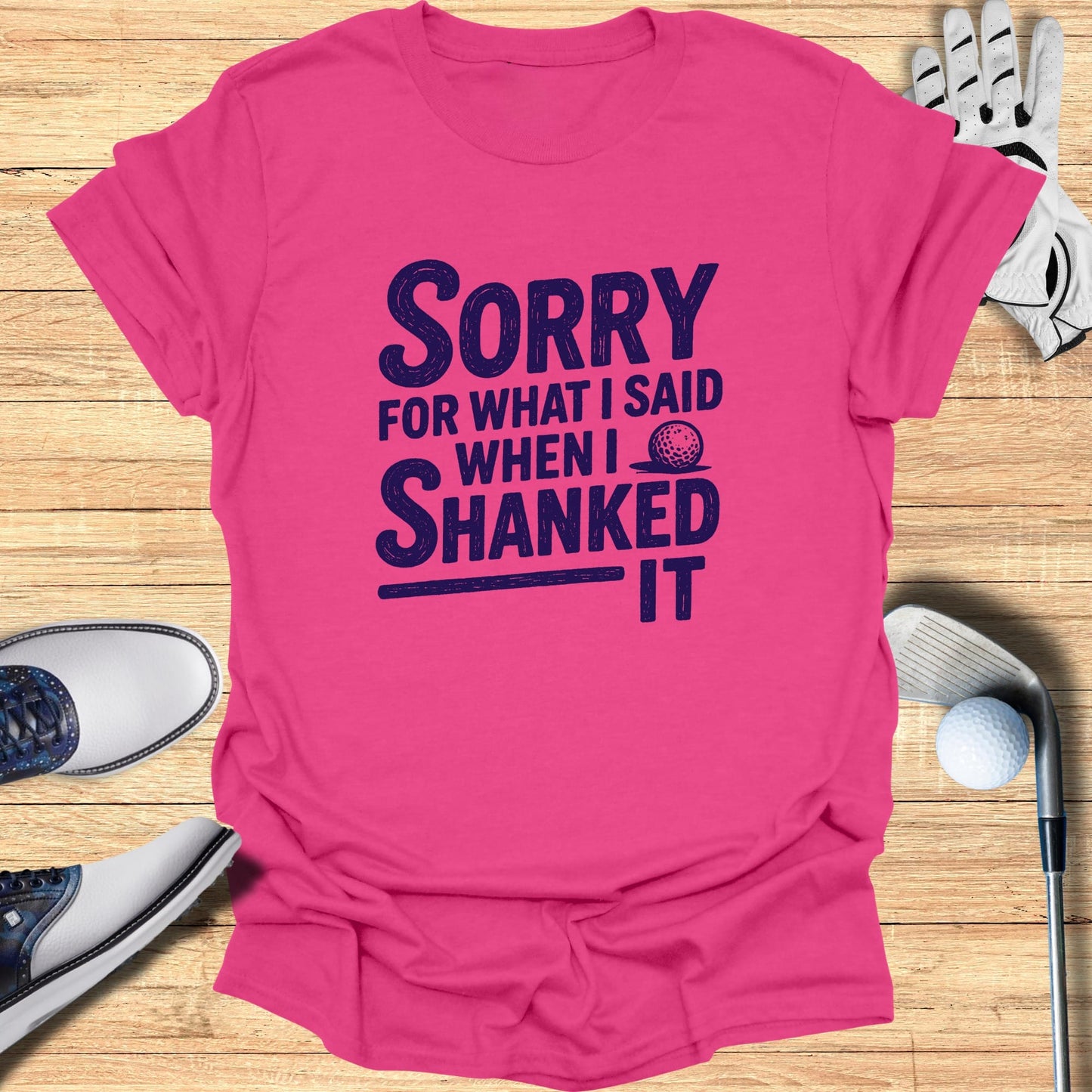 Pink t-shirt with "Sorry for what I said when I shanked it" in dark blue text.