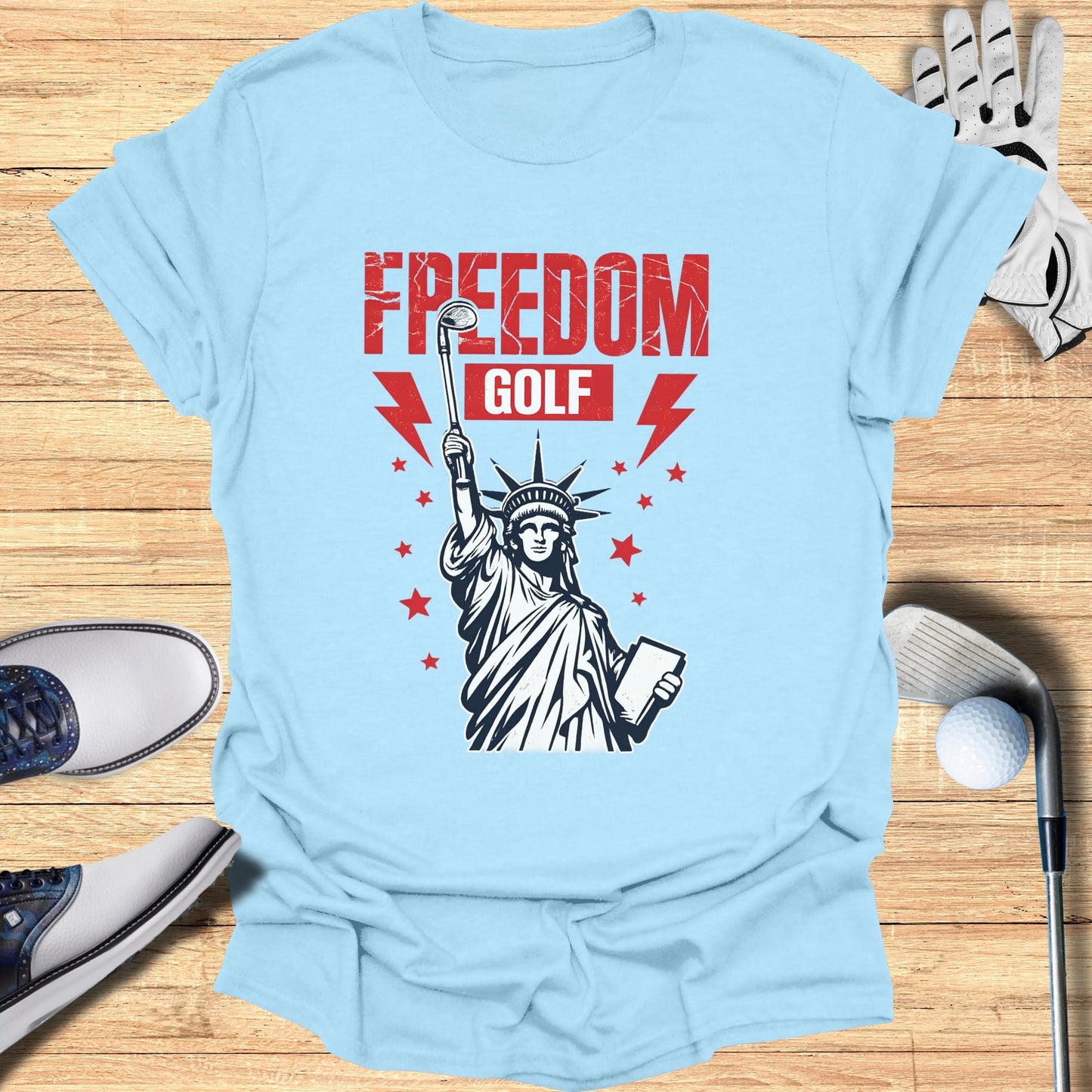 Light blue t-shirt with Statue of Liberty graphic and "FREEDOM GOLF" text.