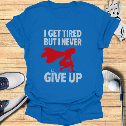 Blue t-shirt with text "I GET TIRED BUT I NEVER GIVE UP" and graphic.