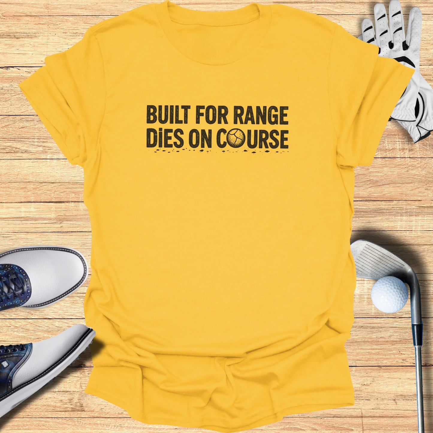 Yellow t-shirt with "Built for range, dies on course" text and golf accessories.