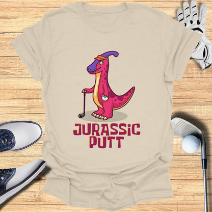 T-shirt with cartoon dinosaur playing golf, text "Jurassic Putt".