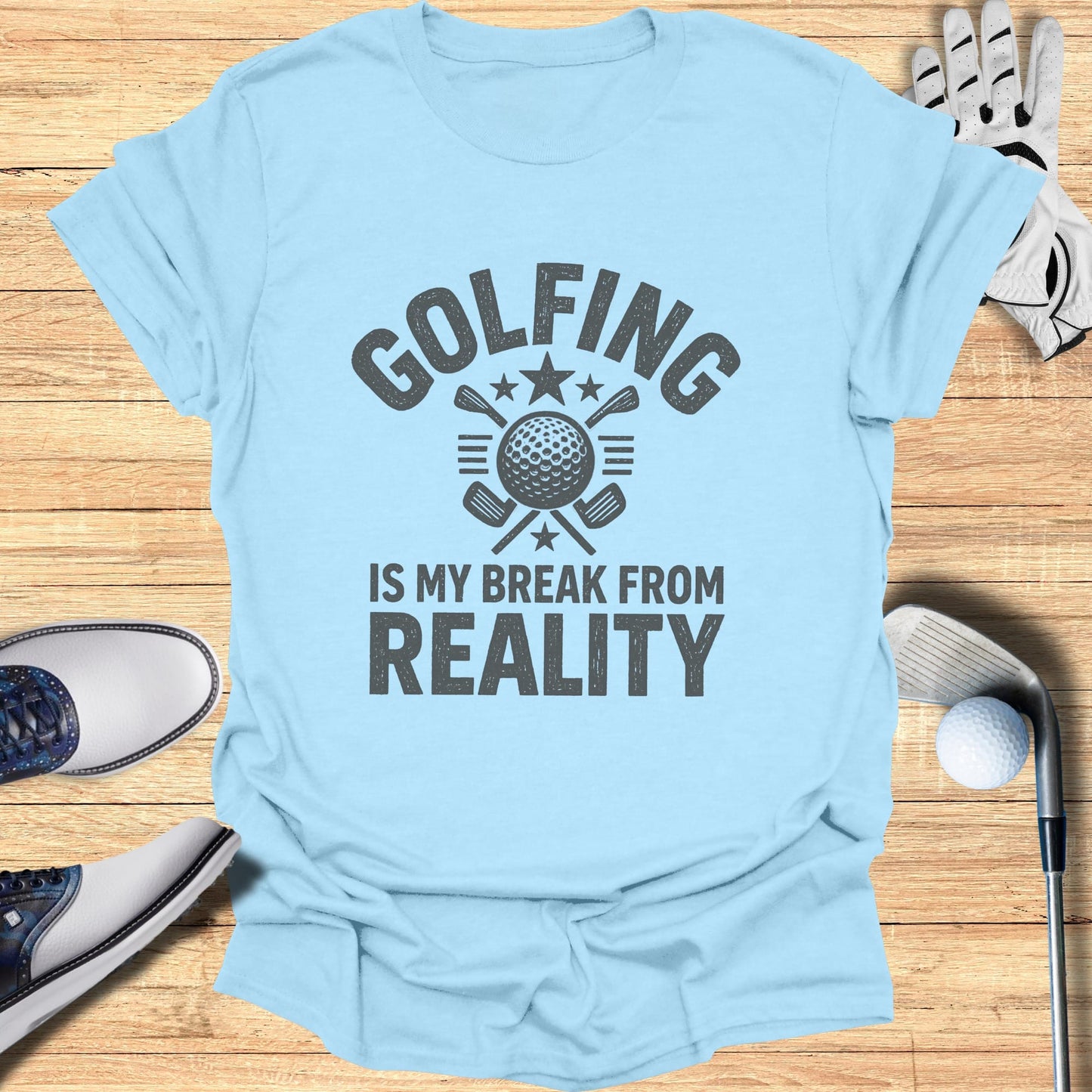 Light blue t-shirt with "GOLFING IS MY BREAK FROM REALITY" text and golf imagery.