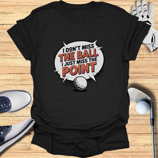 Black t-shirt with "I don't miss the ball I just miss the point" and golf ball graphic.