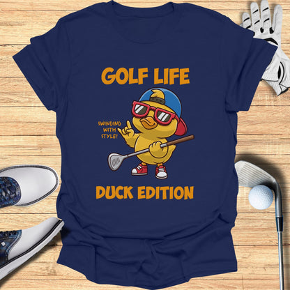 Blue t-shirt with cartoon duck golfer wearing sunglasses and holding a club.
