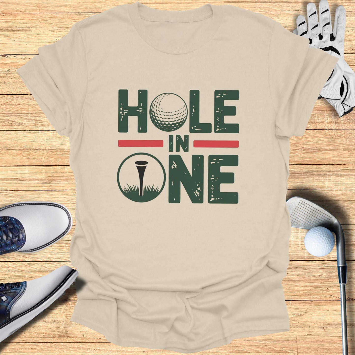 T-shirt with "HOLE IN ONE" text, golf ball, and flag.