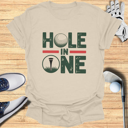 T-shirt with "HOLE IN ONE" text, golf ball, and flag.
