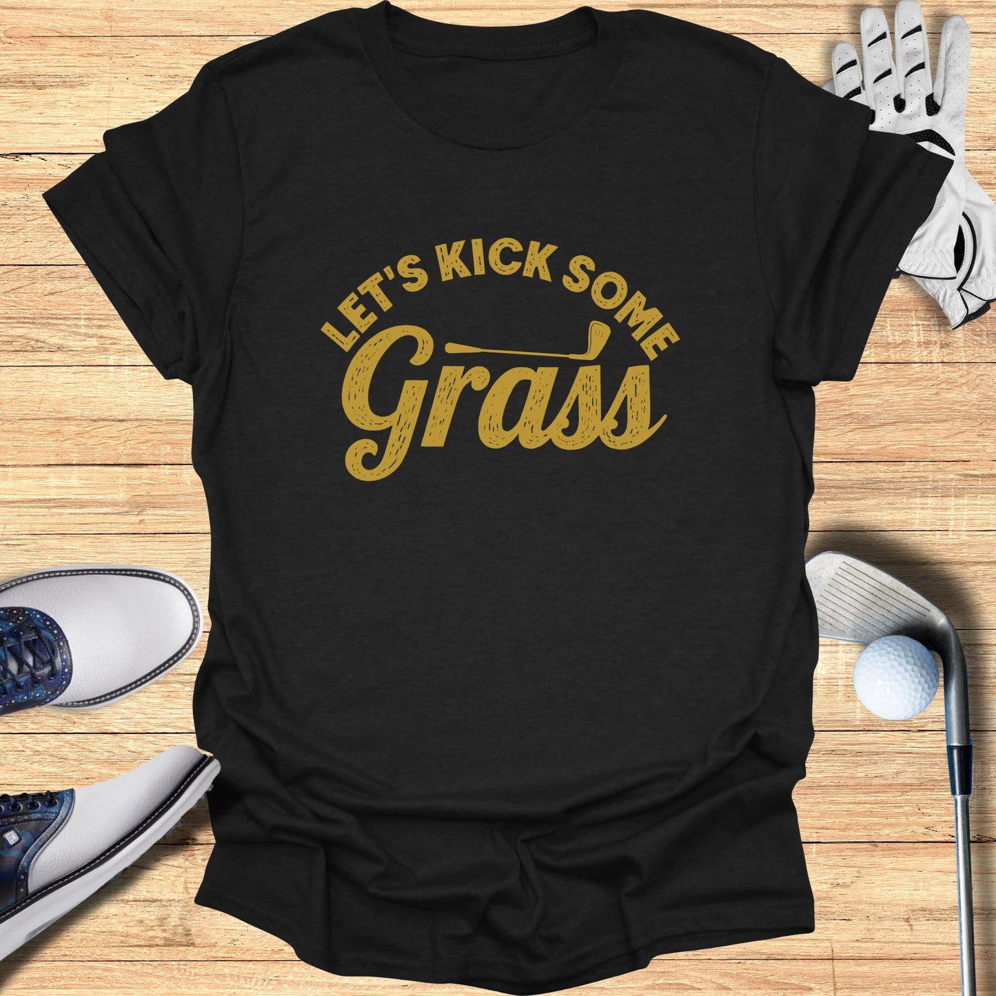 Black t-shirt with "Let's Kick Some Grass" text in gold lettering.