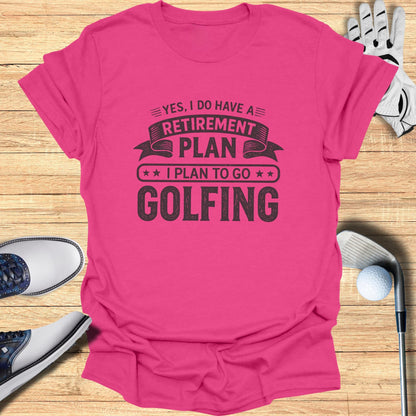 Pink t-shirt with "Retirement Plan: Golfing" text, surrounded by golf clubs and balls.
